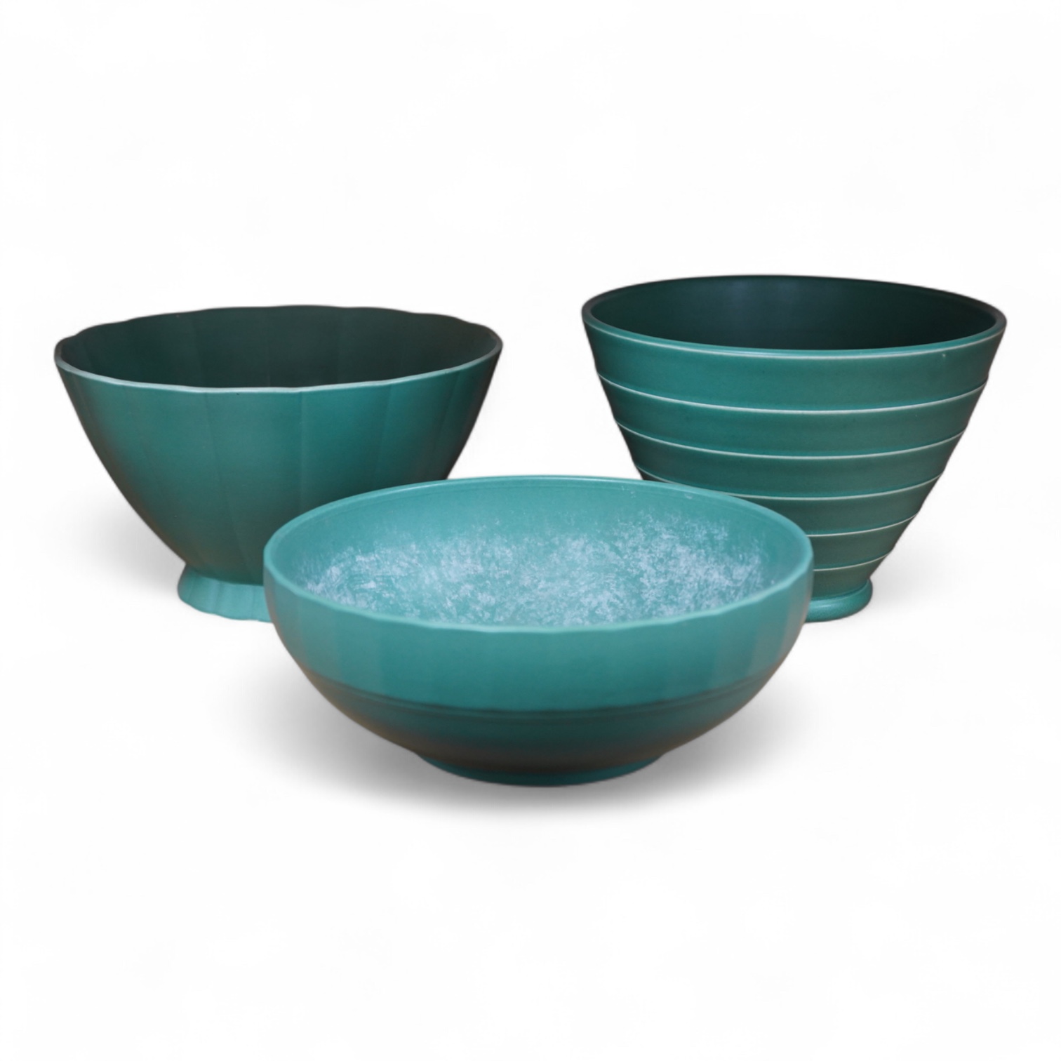 Keith Murray for Wedgwood, three green glazed bowls to include a ribbed example, largest 24cm in diameter